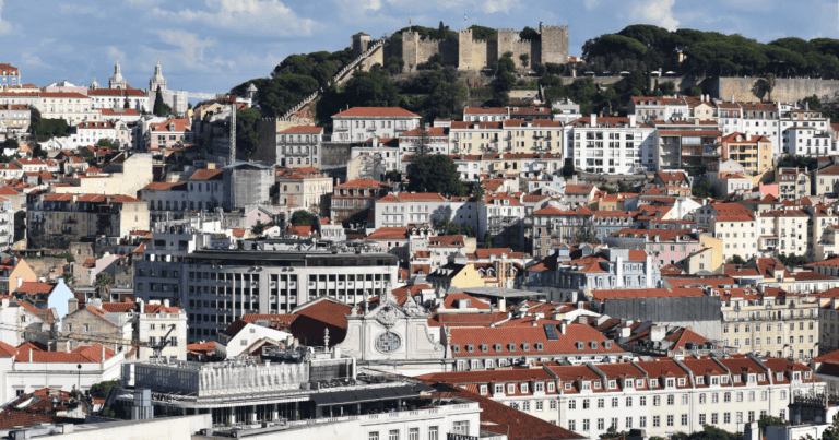 Panoramic view of Lisbon rooftops and São Jorge Castle seen from a viewpoint in Lisbon