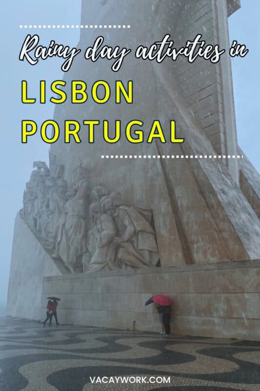 People holding umbrellas near the Padrão dos Descobrimentos monument in Lisbon during heavy rain, with text overlay that says Rainy day activities in Lisbon Portugal.