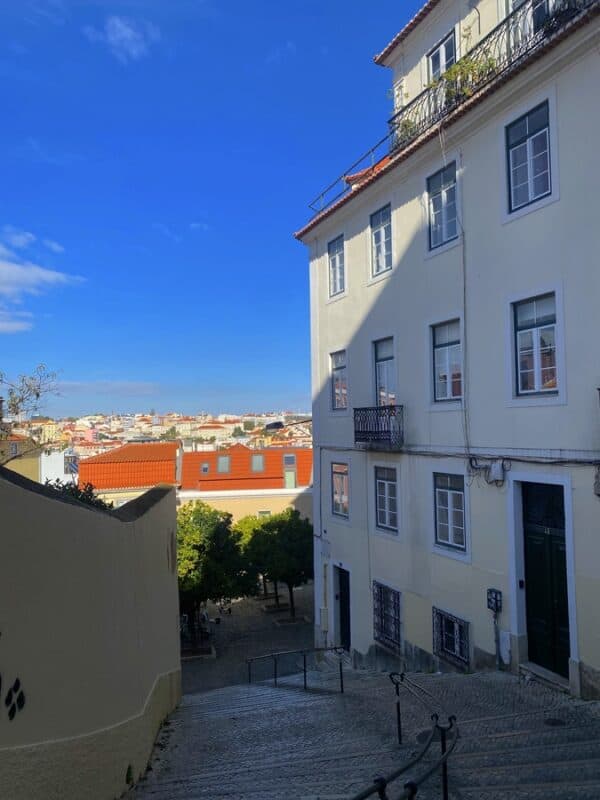 Rua da Mãe d'Água in Lisbon with staircases, historic buildings and rooftop views across the city