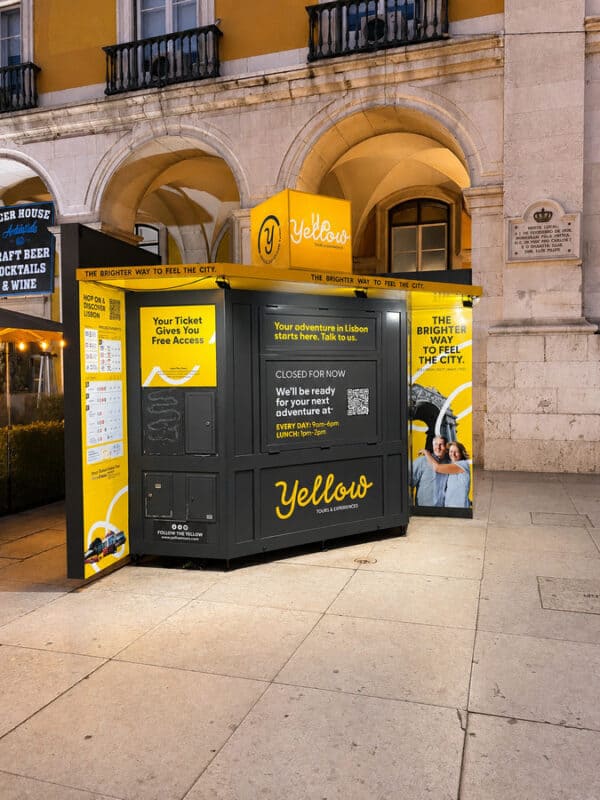 Yellow Bus Tours kiosk in Lisbon city centre selling sightseeing passes and hop-on hop-off tour tickets.