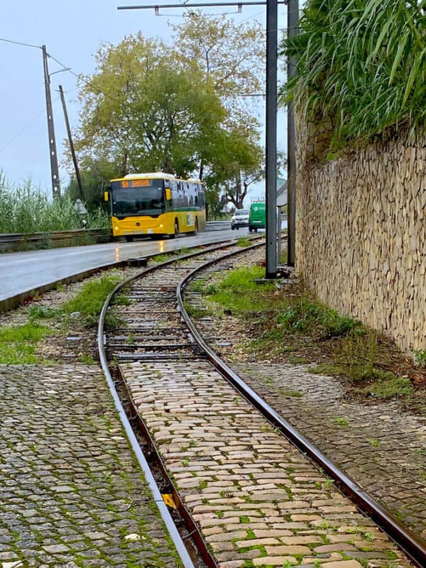 Carris Metropolitana Bus 1624 to Cascais beside the tram tracks in Sintra on a rainy day