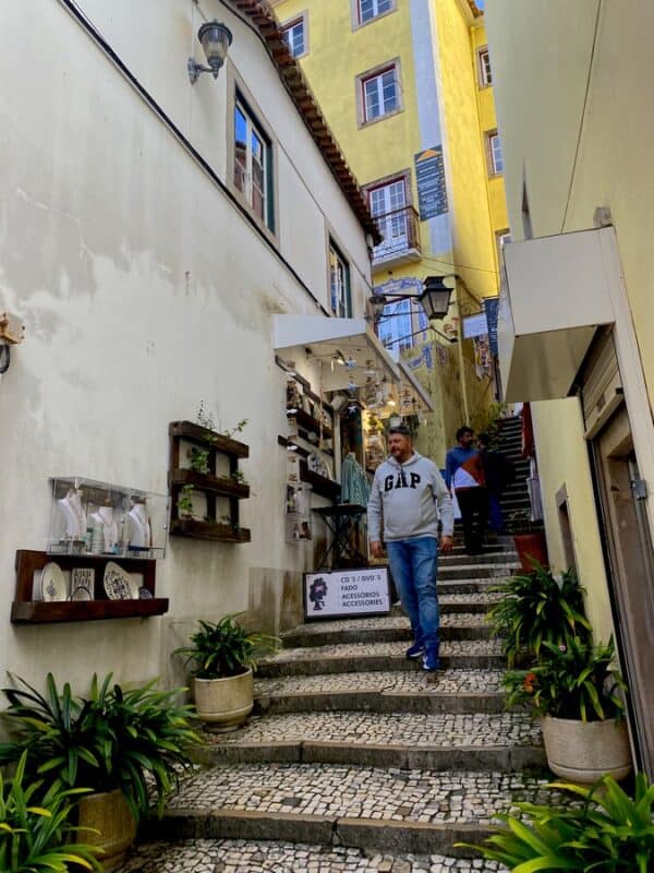 Long flight of steps in a narrow alley of Sintra Historic Centre lined with old buildings and souvenir shops