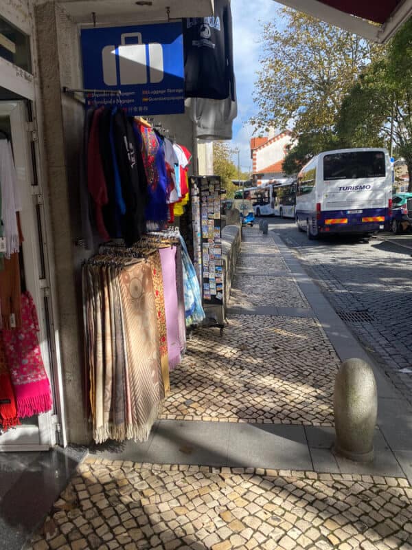 Street scene in Sintra with souvenir stalls and tour buses.