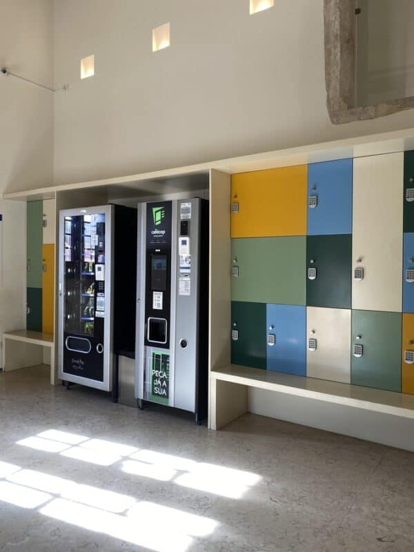 Vending machines and colorful lockers in a modern indoor space.