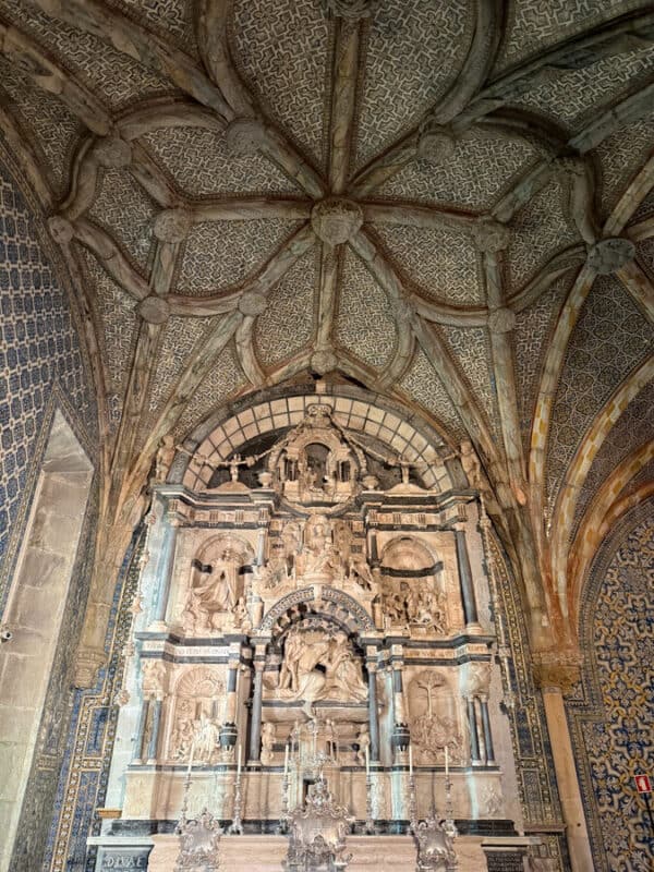 Intricate Baroque church interior with ornate stone carvings and vaulted ceiling.