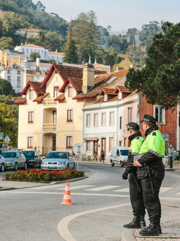 Portuguese police guarding the pedestrian entrance to Sintra Historic Centre with Romantic style buildings