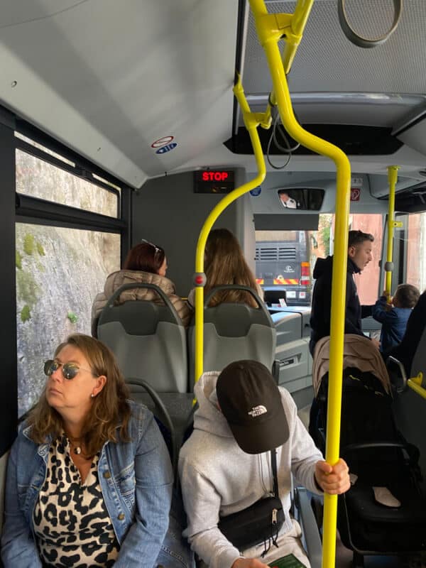 Tourists inside the Sintra Loop bus travelling along a narrow road.