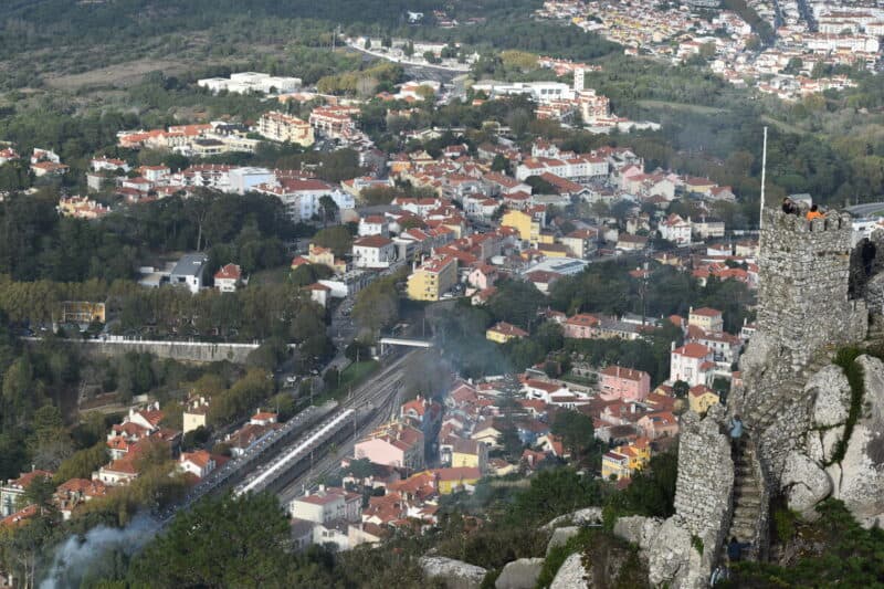 Scenic view of Sintra with historic castle ruins and colorful town below.