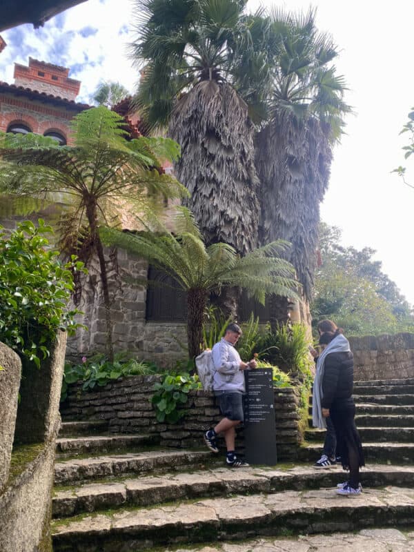 Tourists exploring historic Sintra with lush greenery and ancient architecture.