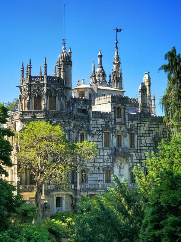Quinta da Regaleira palace viewed through lush green gardens
