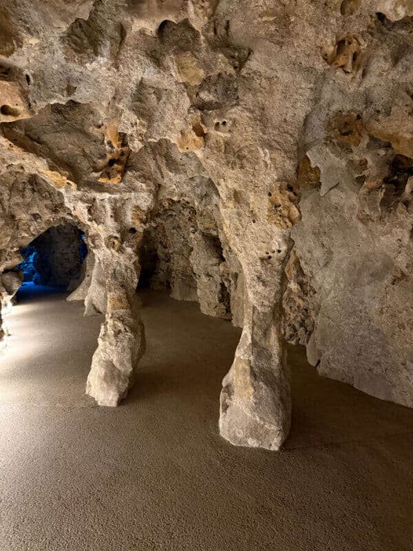 Quinta da Regaleira underground grotto with rough stone pillars and paths