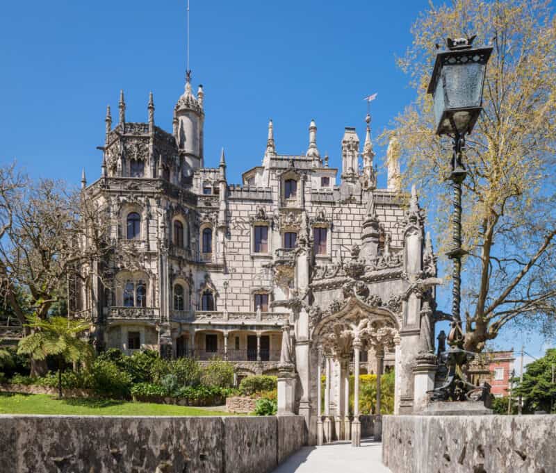 Quinta da Regaleira palace and entrance surrounded by gardens and trees