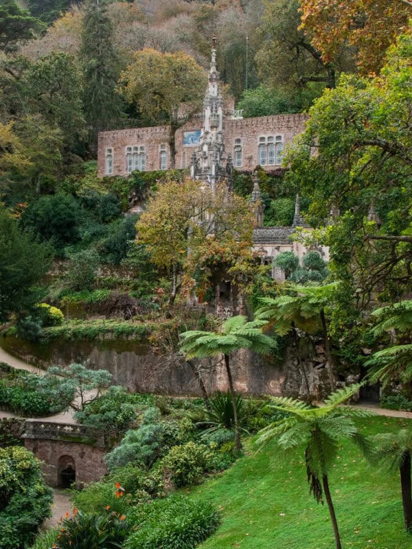 Quinta da Regaleira garden with a stone building estufa and lush planting