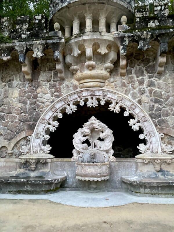 Quinta da Regaleira carved fountain set into a stone wall