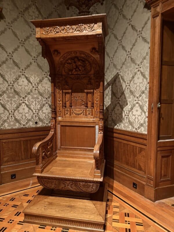Quinta da Regaleira interior with a carved wooden chair and tiled floor