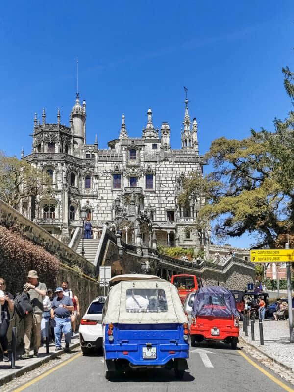 Quinta da Regaleira palace beside busy roads and tourist vehicles