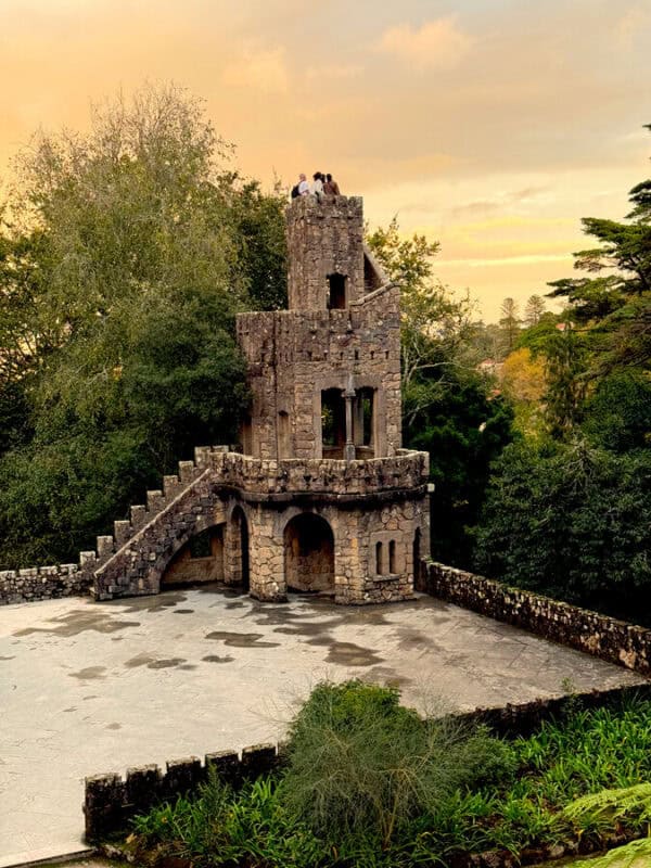 Quinta da Regaleira Ziggurat tower rising above the garden at sunset