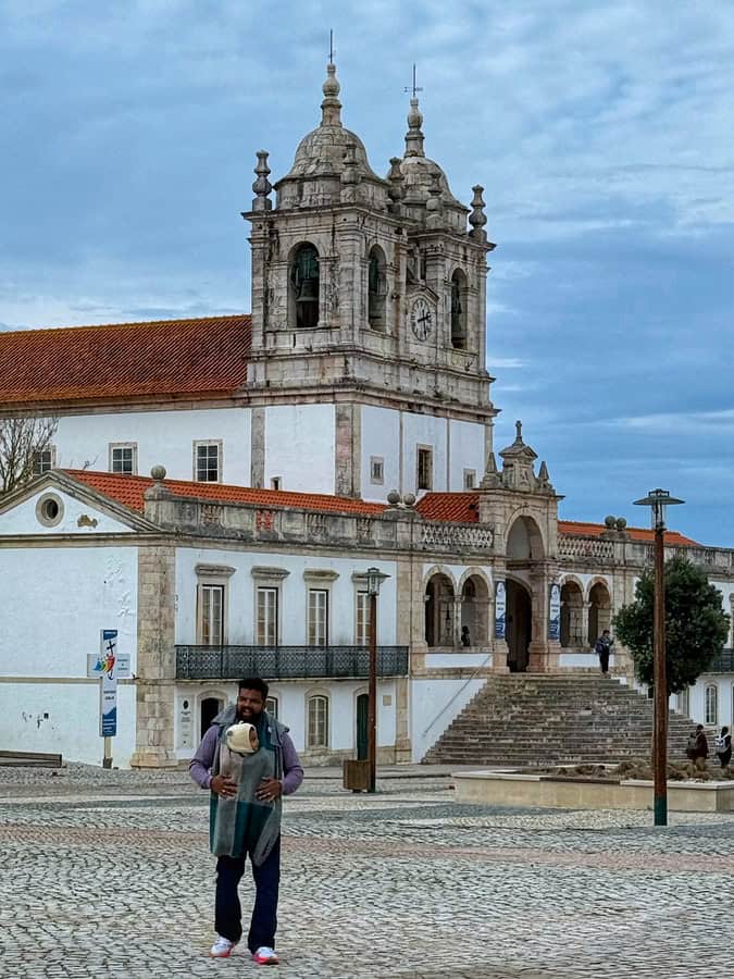 vacaywork author ashrith carrying his son walking in front of Sanctuary of Our Lady of Nazareth